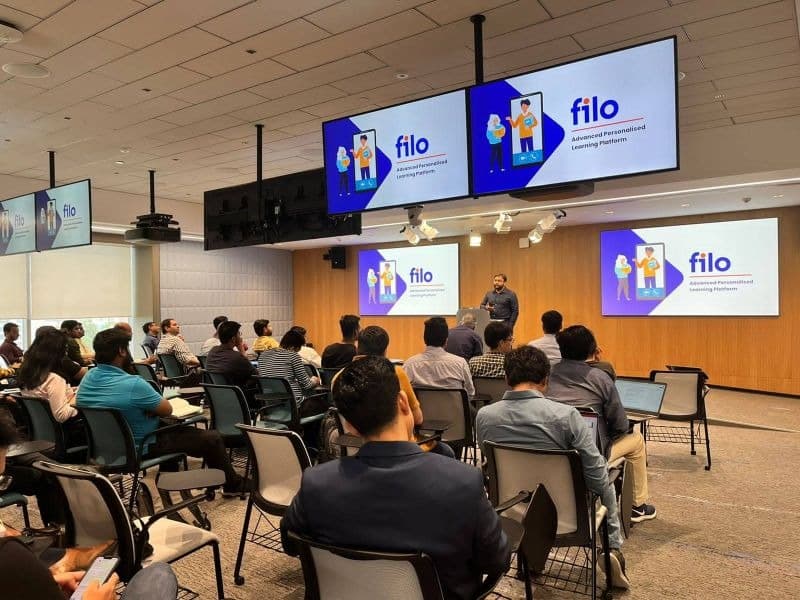 Team presentation at the Filo office, with Filo branding on the screens